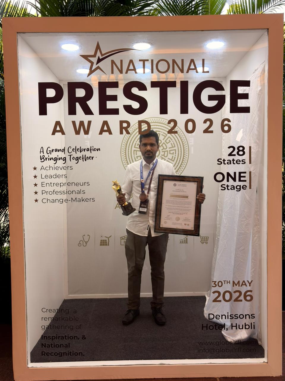 Er. Panchakshari Kalasad at National Prestige Award 2026 backdrop with trophy and certificate